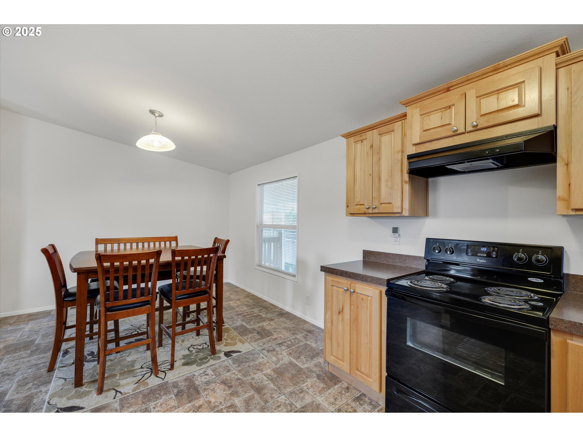 21100 Northeast Sandy Boulevard, Unit 39 Fairview, OR 97024 - Photo 10 of 23 a kitchen with stainless steel appliances granite countertop a stove a sink a microwave and dining table