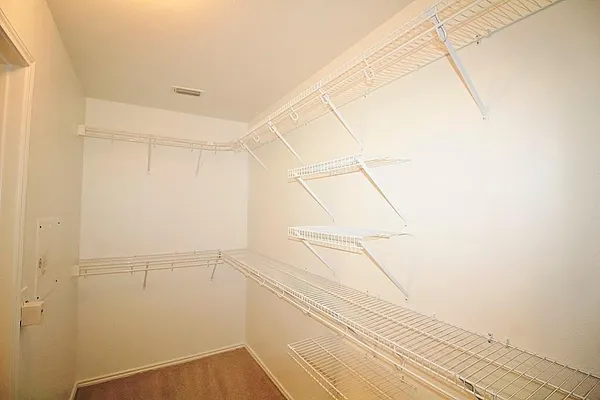 a view of a closet and an empty room