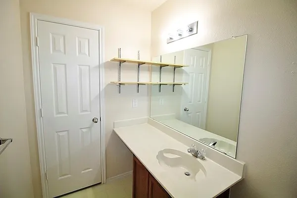 a bathroom with a sink and mirror