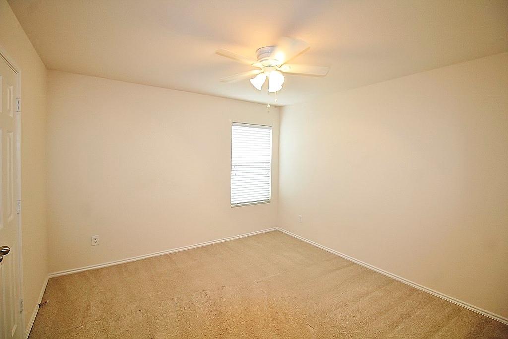 1920 J J Cheshier Road Fort Worth, TX 76247 - Photo 15 of 21 an empty room with a chandelier fan and windows
