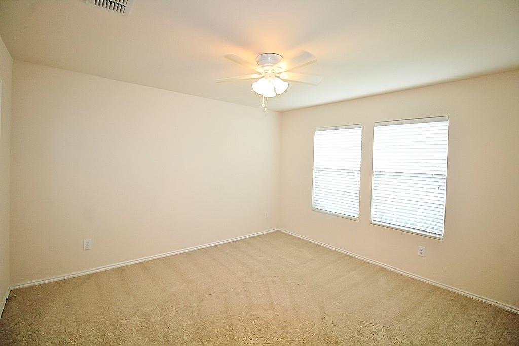 1920 J J Cheshier Road Fort Worth, TX 76247 - Photo 17 of 21 an empty room with a window and a fan