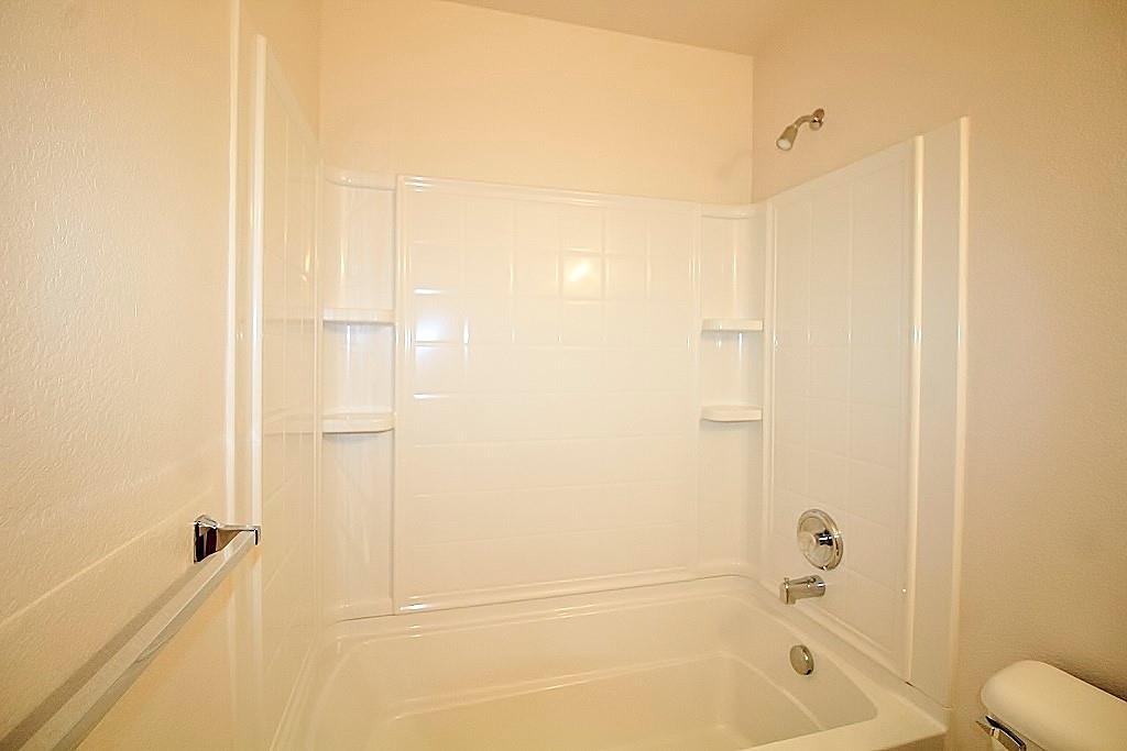 1920 J J Cheshier Road Fort Worth, TX 76247 - Photo 18 of 21 a bathroom with a bathtub