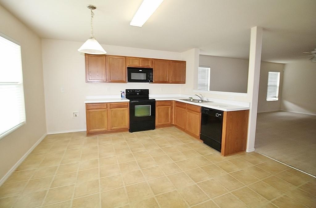 1920 J J Cheshier Road Fort Worth, TX 76247 - Photo 3 of 21 a view of kitchen with stainless steel appliances granite countertop a stove top oven a sink dishwasher and a refrigerator