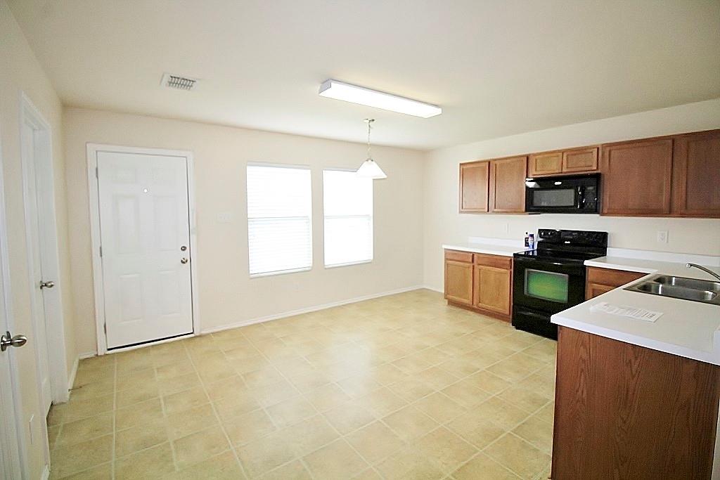 1920 J J Cheshier Road Fort Worth, TX 76247 - Photo 5 of 21 a kitchen with stainless steel appliances granite countertop a stove a sink and a refrigerator