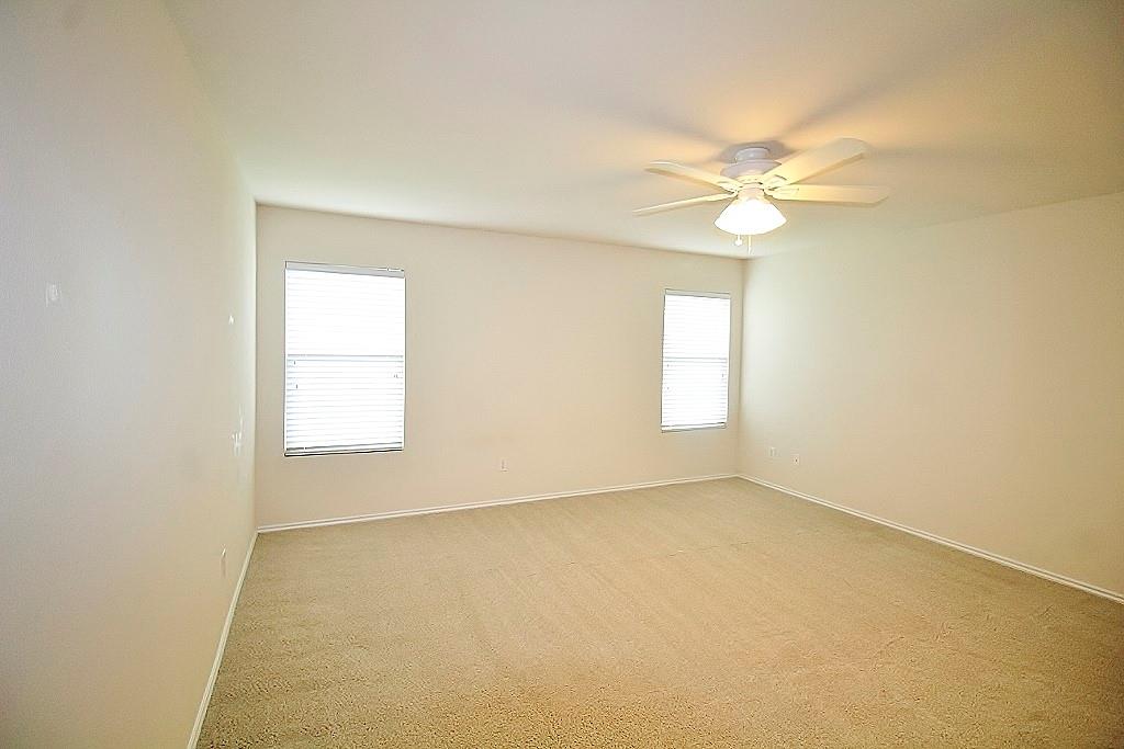 1920 J J Cheshier Road Fort Worth, TX 76247 - Photo 9 of 21 an empty room with a window and a ceiling fan