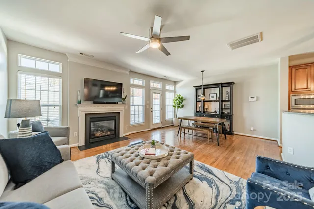 a living room with furniture fireplace and a window