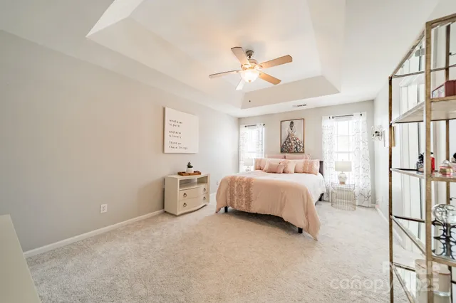 a bedroom with a white bed and white walls