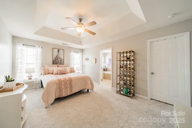 a spacious bedroom with a bed and a chandelier