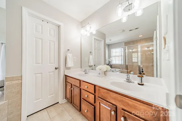 a bathroom with double vanity sink and a mirror