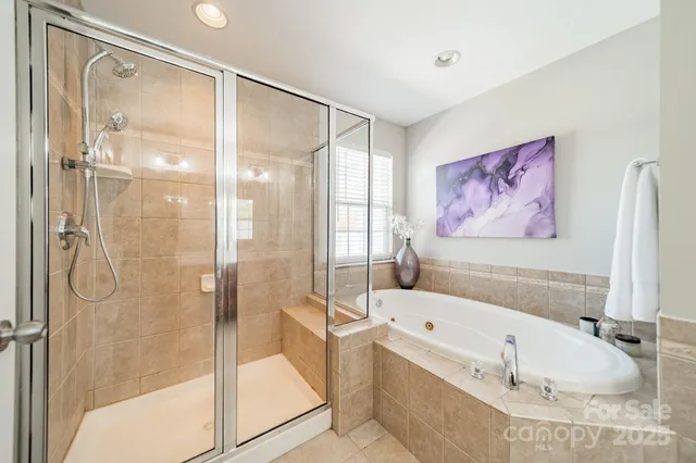 a bathroom with a tub and a shower