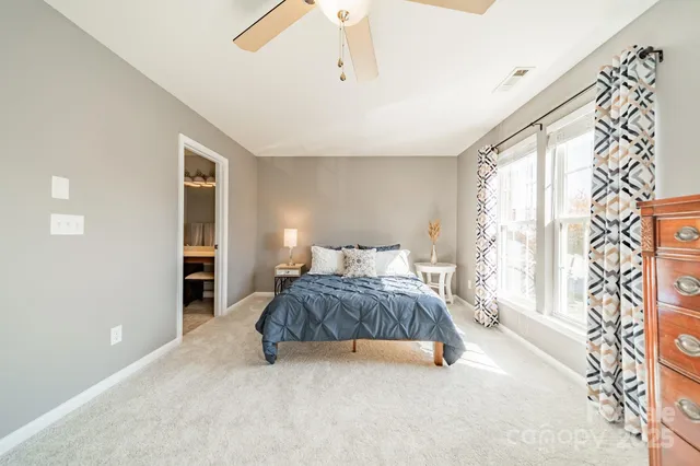 a spacious bedroom with a bed and a window