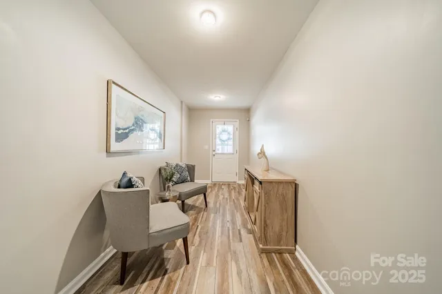 a view of a workspace with furniture and wooden floor