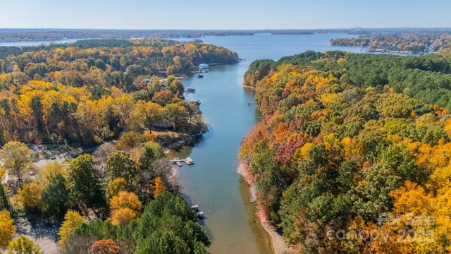 an aerial view of a house with a lake view