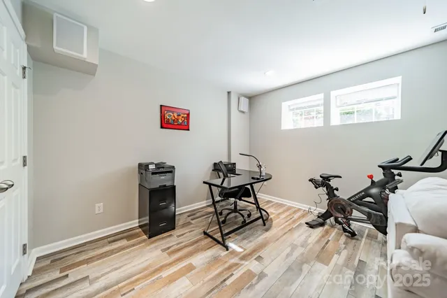 a view of a workspace with furniture and a window