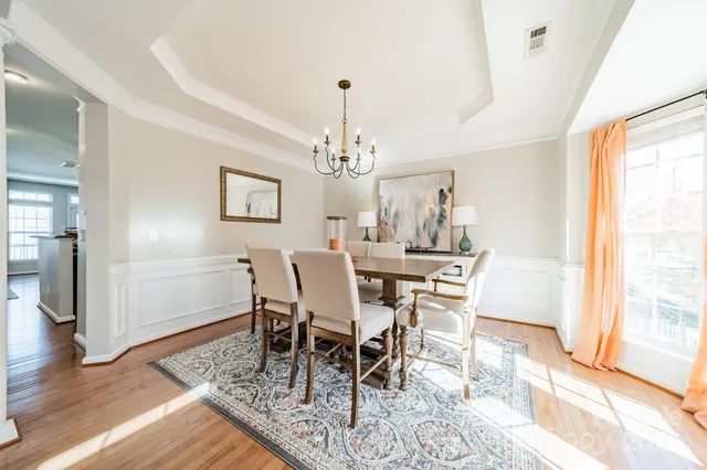 a view of a dining room with furniture window and wooden floor