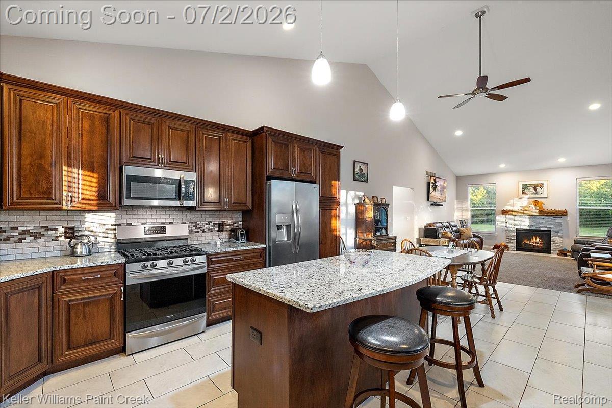 54230 Card Road Macomb, MI 48042 - Photo 39 of 73 Open-concept kitchen and living area featuring vaulted ceilings