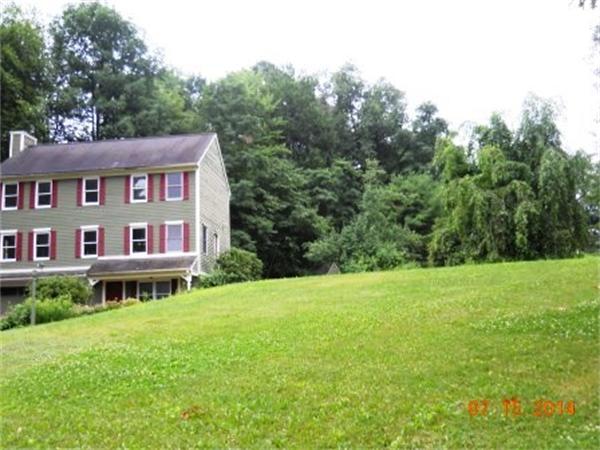 104 Lunenburg Road Townsend, MA 01474 - Photo 2 of 11 a view of a big house with a big yard and large trees