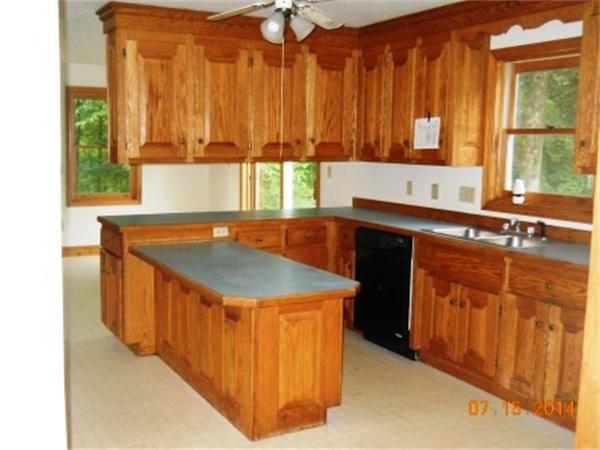 104 Lunenburg Road Townsend, MA 01474 - Photo 4 of 11 a kitchen with stainless steel appliances granite countertop a sink and a stove