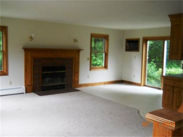 104 Lunenburg Road Townsend, MA 01474 - Photo 6 of 11 a view of an empty room with window and fire place