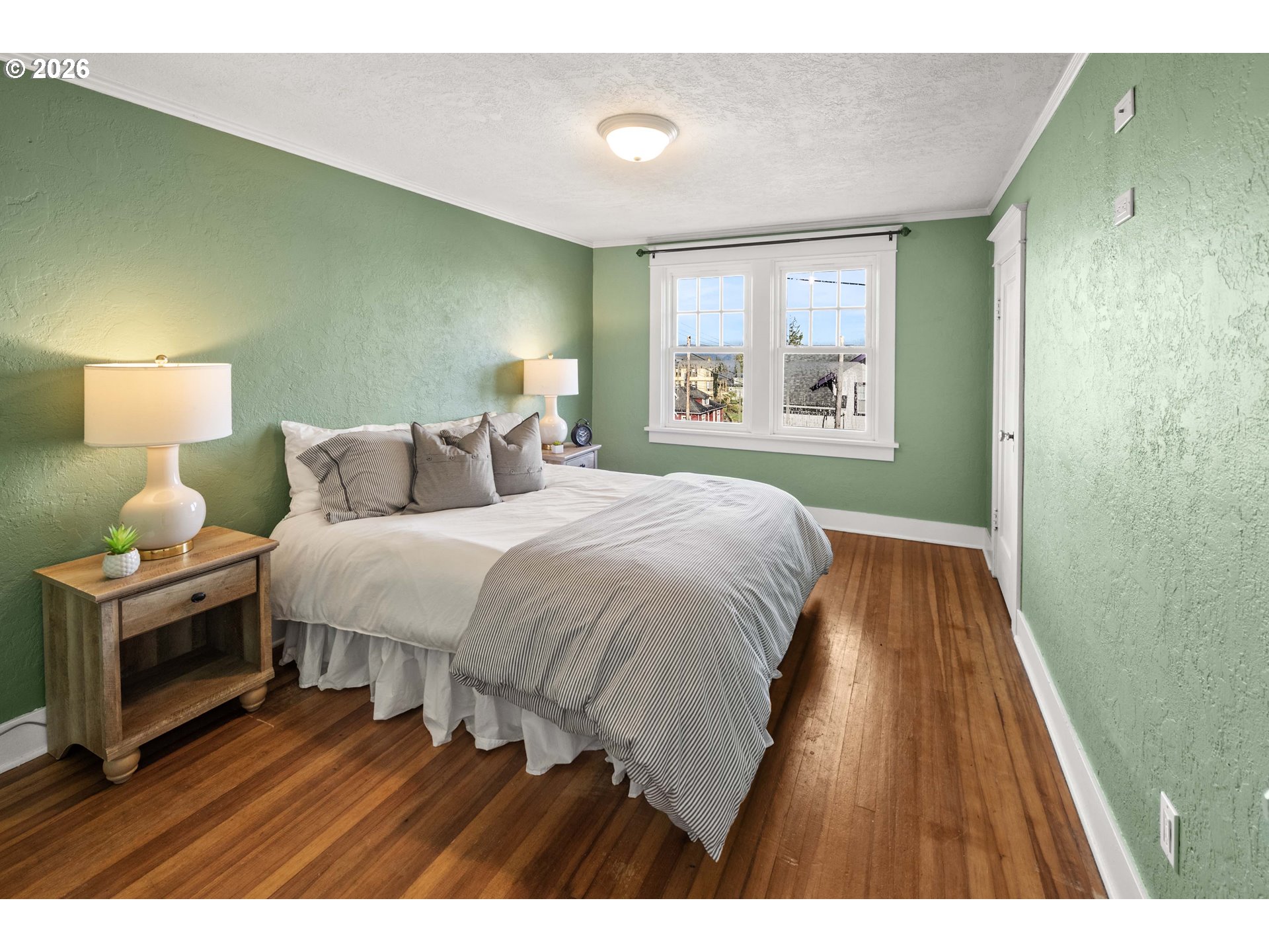 1014 8th Street Astoria, OR 97103 - Photo 14 of 25 a bedroom with a bed and a night stand
