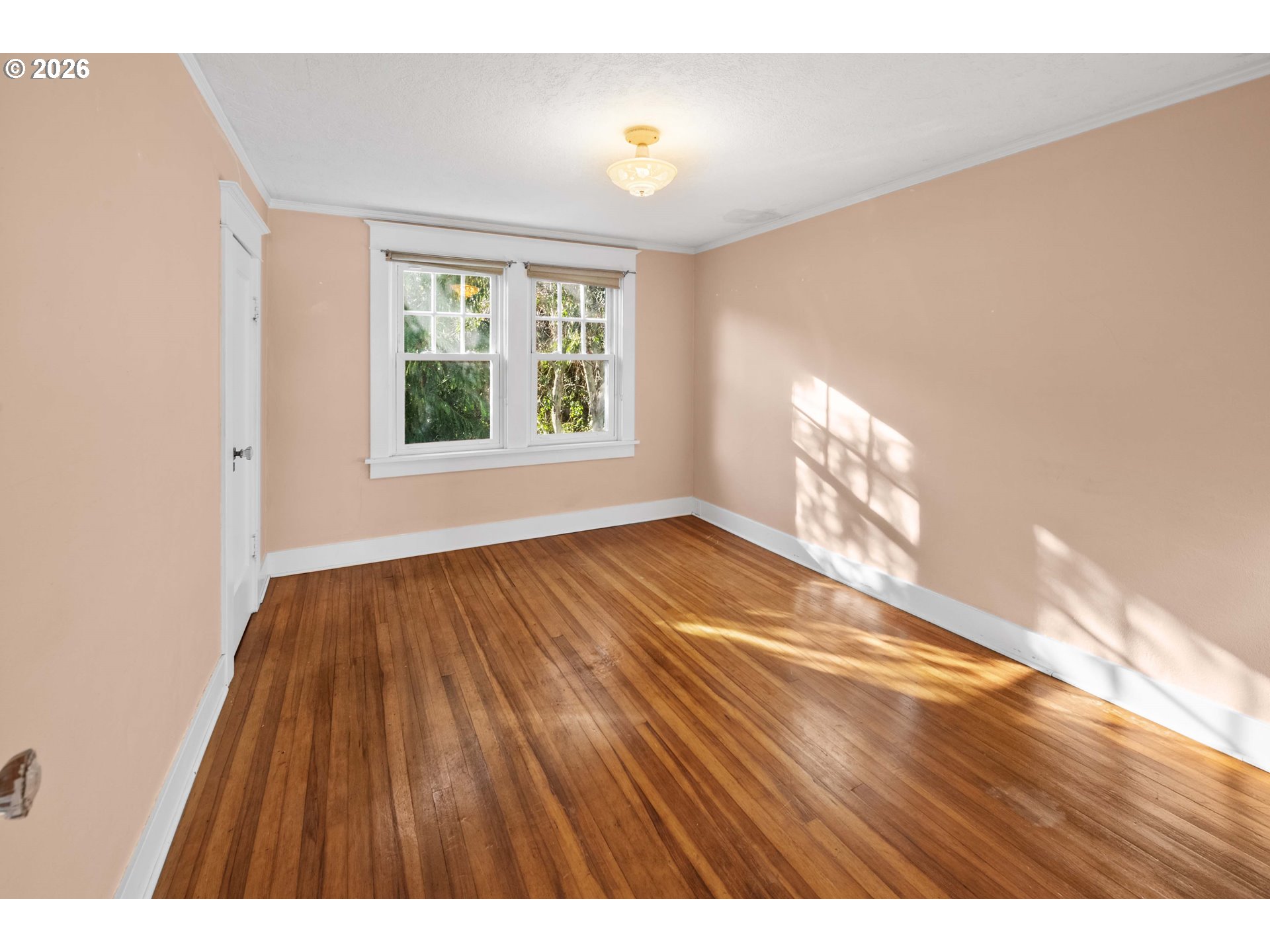 1014 8th Street Astoria, OR 97103 - Photo 15 of 25 a view of an empty room with wooden floor and a window