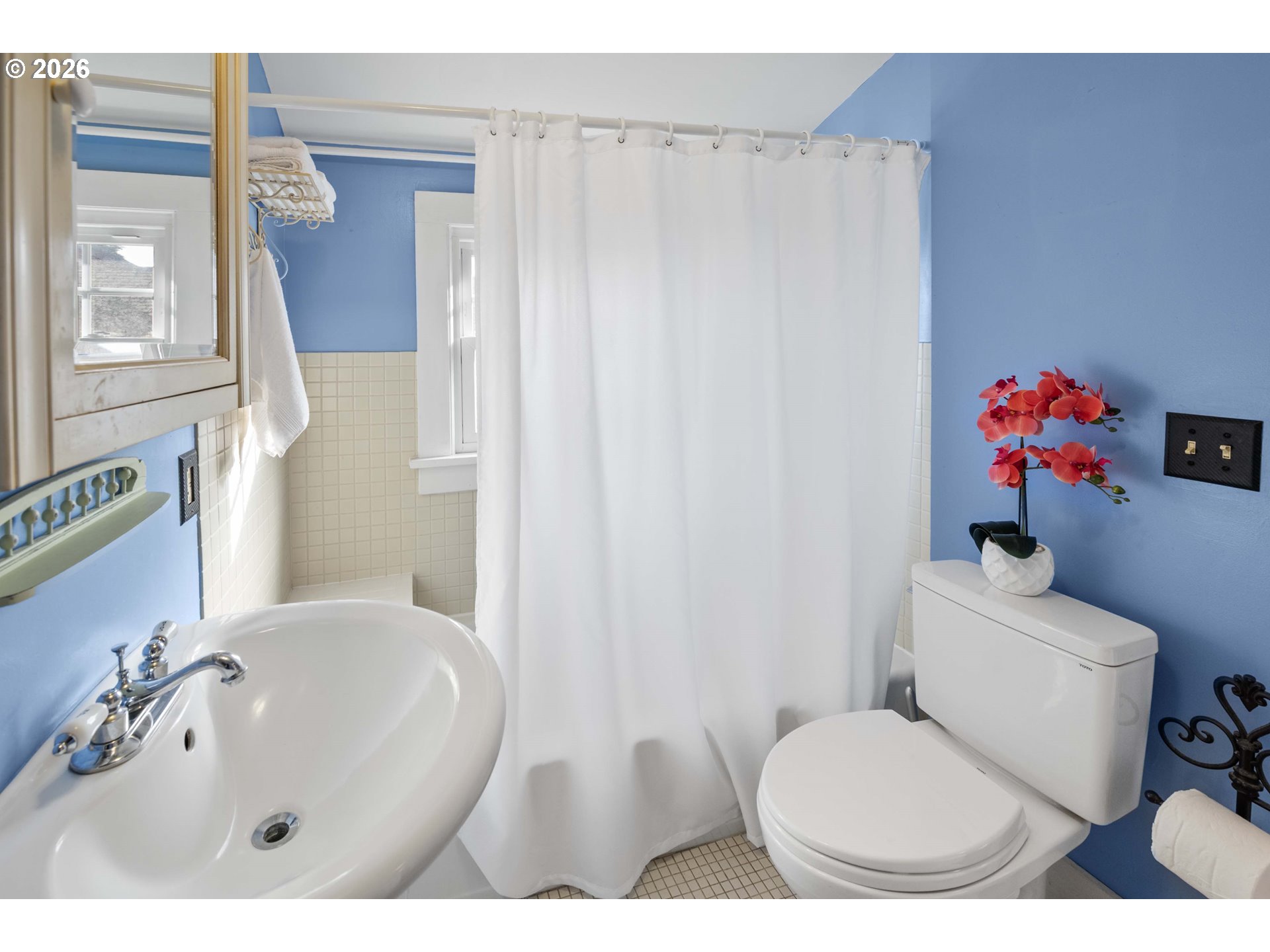 1014 8th Street Astoria, OR 97103 - Photo 17 of 25 a bathroom with a sink toilet and shower