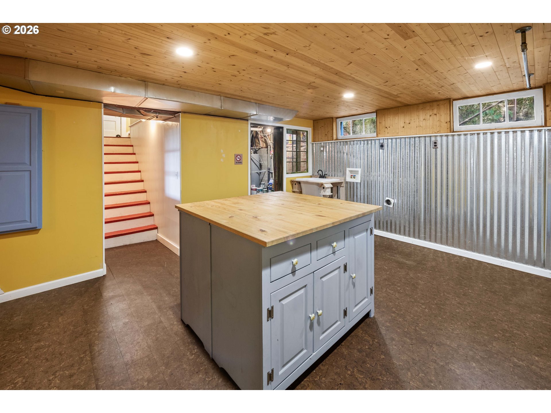 1014 8th Street Astoria, OR 97103 - Photo 18 of 25 a kitchen with a sink and dishwasher with wooden floor