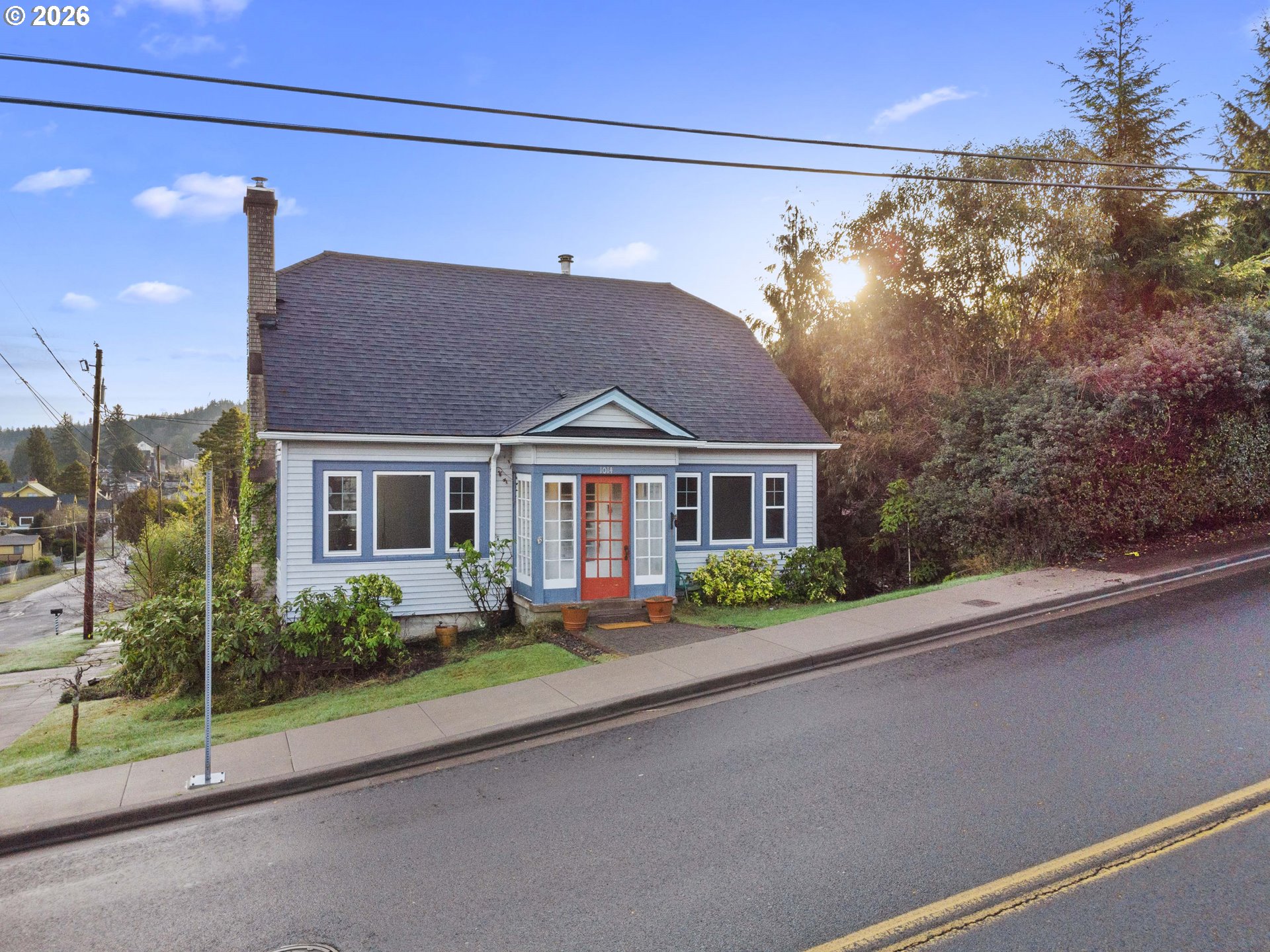1014 8th Street Astoria, OR 97103 - Photo 22 of 25 a front view of a house with a garden and plants