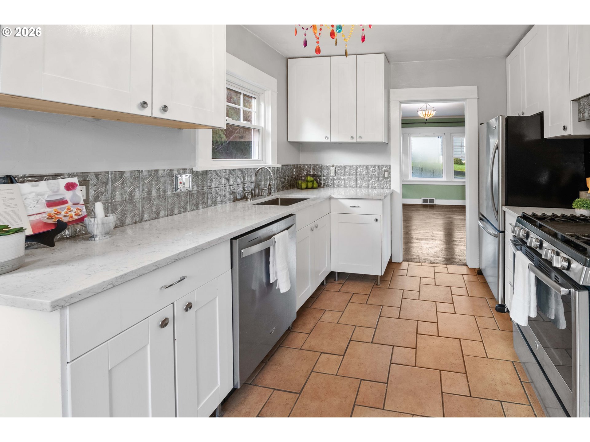 1014 8th Street Astoria, OR 97103 - Photo 9 of 25 a kitchen with stainless steel appliances a sink stove and cabinets