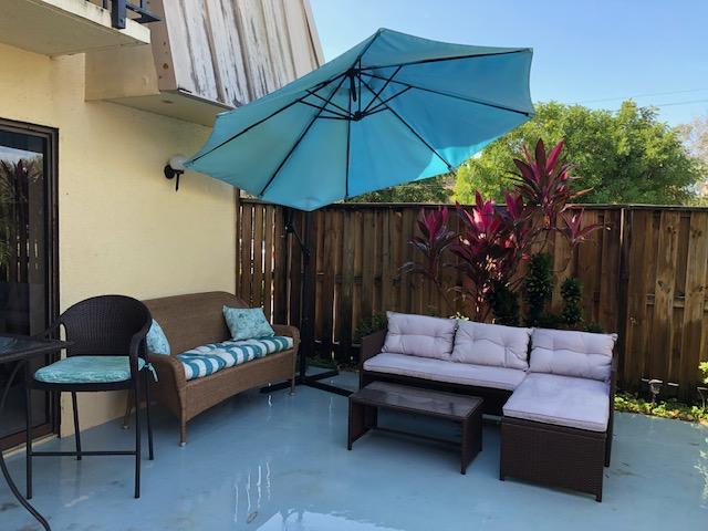 a outdoor sitting area with furniture and a umbrella