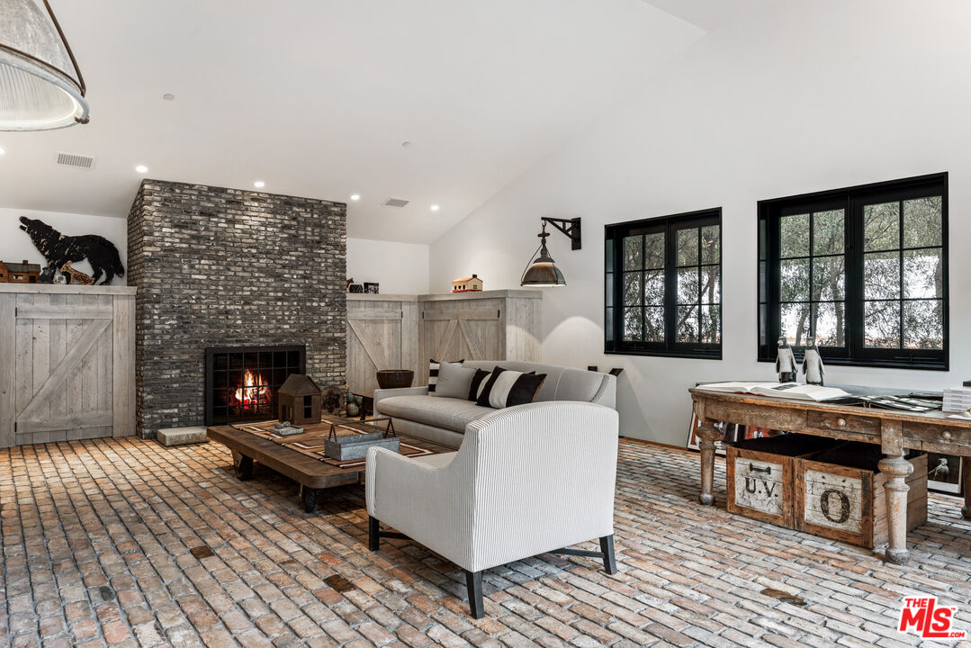 13215 Riviera Ranch Road Los Angeles, CA 90049 - Photo 11 of 37 a living room with furniture and a fireplace
