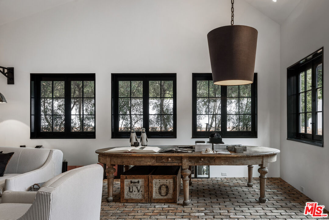 13215 Riviera Ranch Road Los Angeles, CA 90049 - Photo 12 of 37 a view of a dining room with furniture window and wooden floor