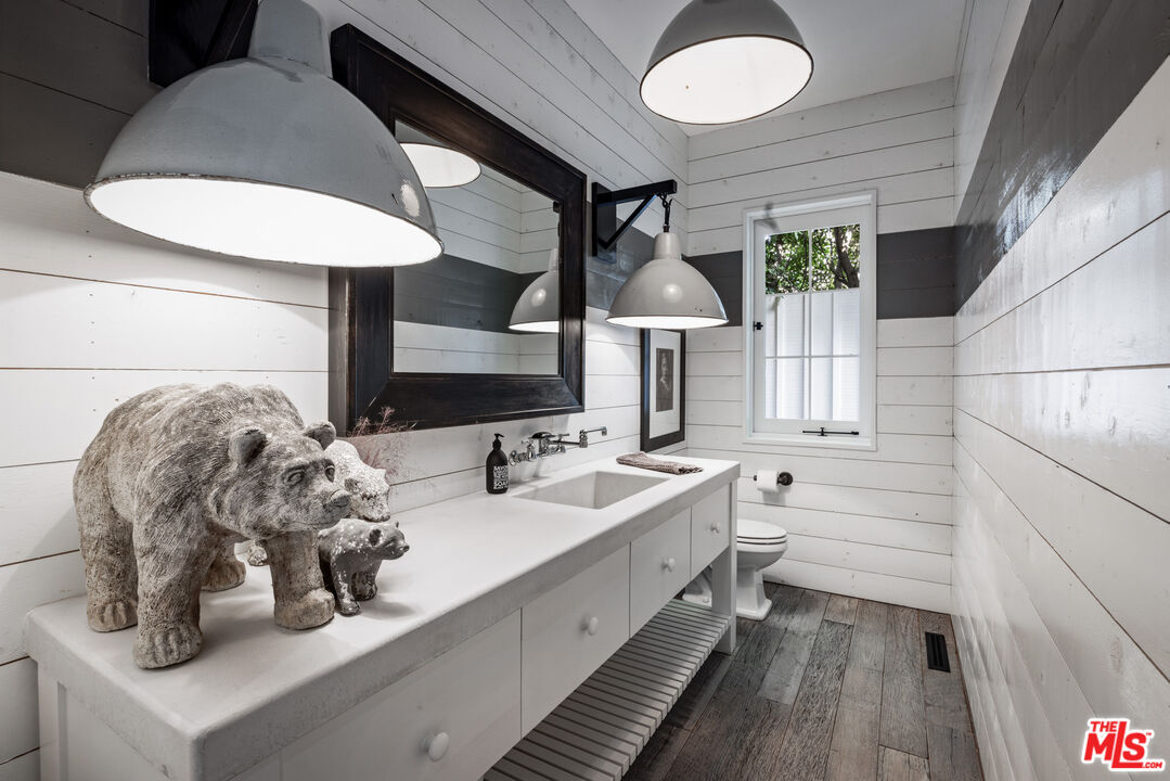13215 Riviera Ranch Road Los Angeles, CA 90049 - Photo 16 of 37 a bathroom with a double vanity sink and a mirror