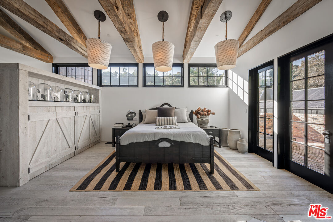 13215 Riviera Ranch Road Los Angeles, CA 90049 - Photo 20 of 37 a bedroom with furniture and a window