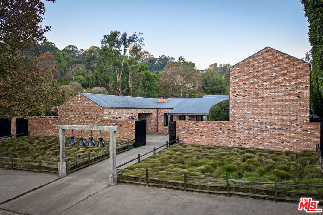 13215 Riviera Ranch Road Los Angeles, CA 90049 - Photo 2 of 37 a view of a house with a yard