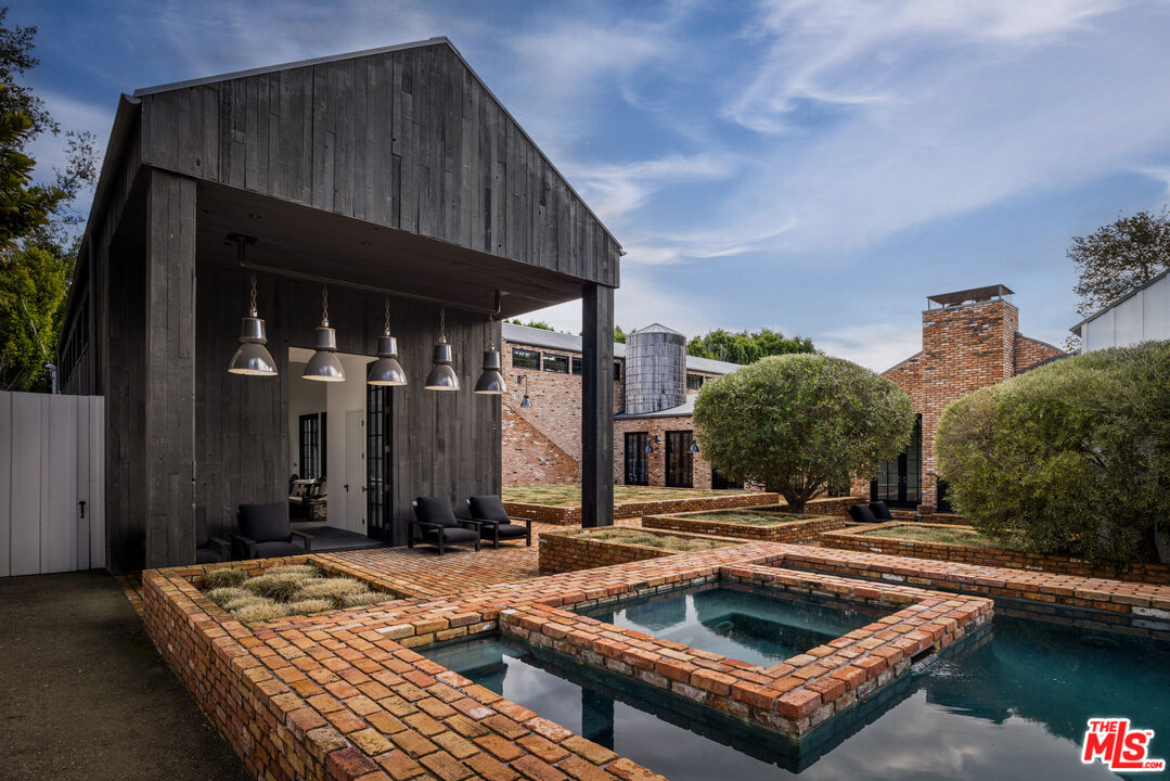 13215 Riviera Ranch Road Los Angeles, CA 90049 - Photo 23 of 37 a view of a house with pool and sitting area
