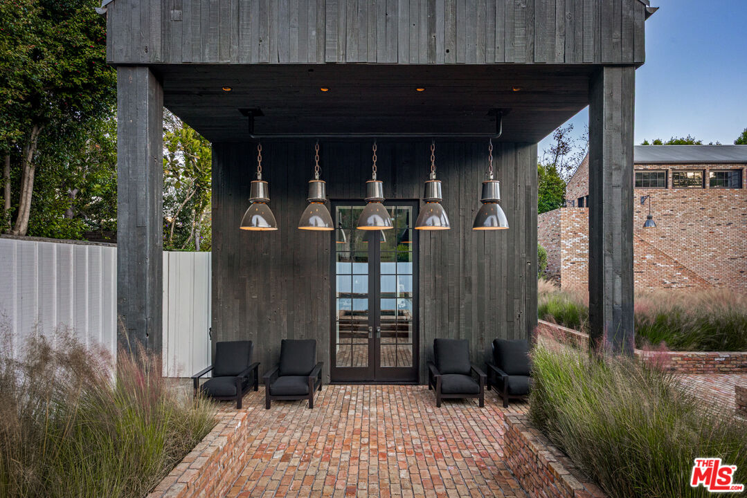 13215 Riviera Ranch Road Los Angeles, CA 90049 - Photo 24 of 37 a view of a house with backyard and porch