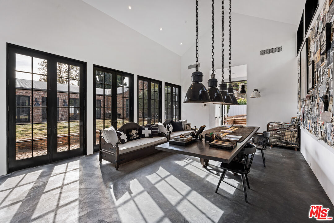 13215 Riviera Ranch Road Los Angeles, CA 90049 - Photo 26 of 37 a living room with furniture and floor to ceiling windows