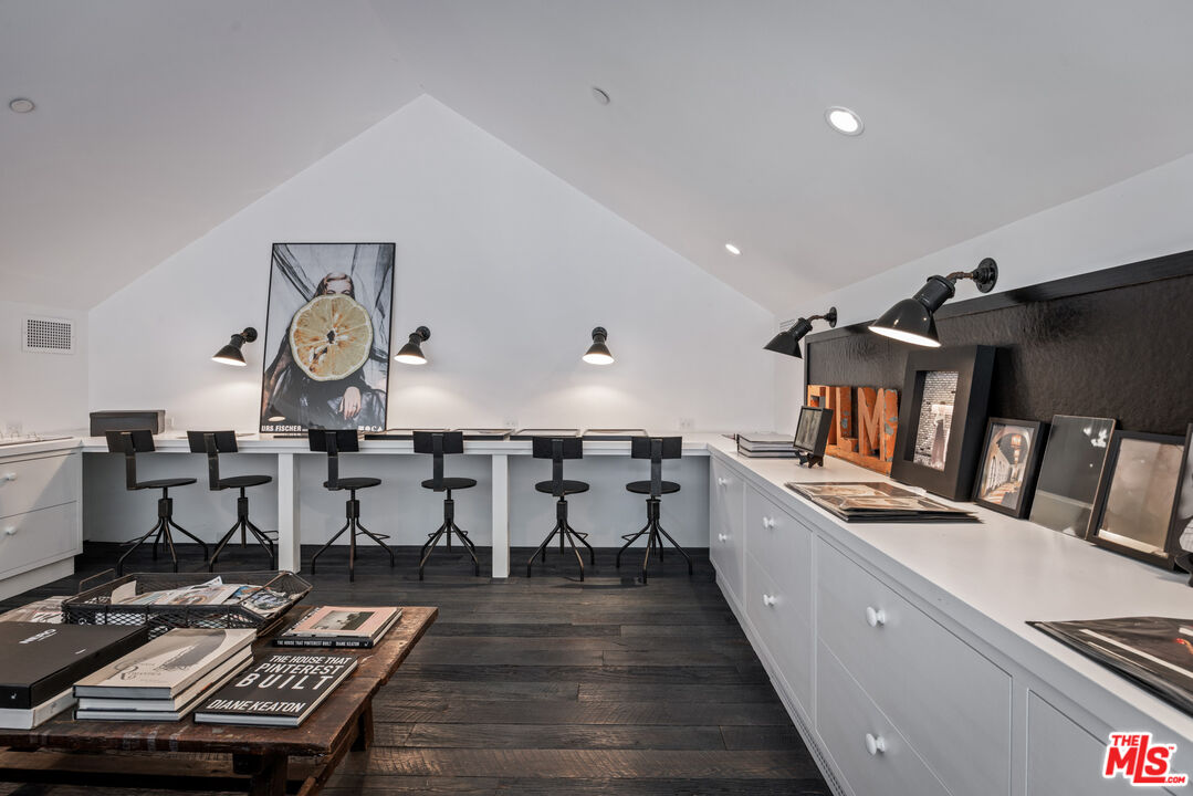 13215 Riviera Ranch Road Los Angeles, CA 90049 - Photo 27 of 37 a kitchen with sink refrigerator and dining table