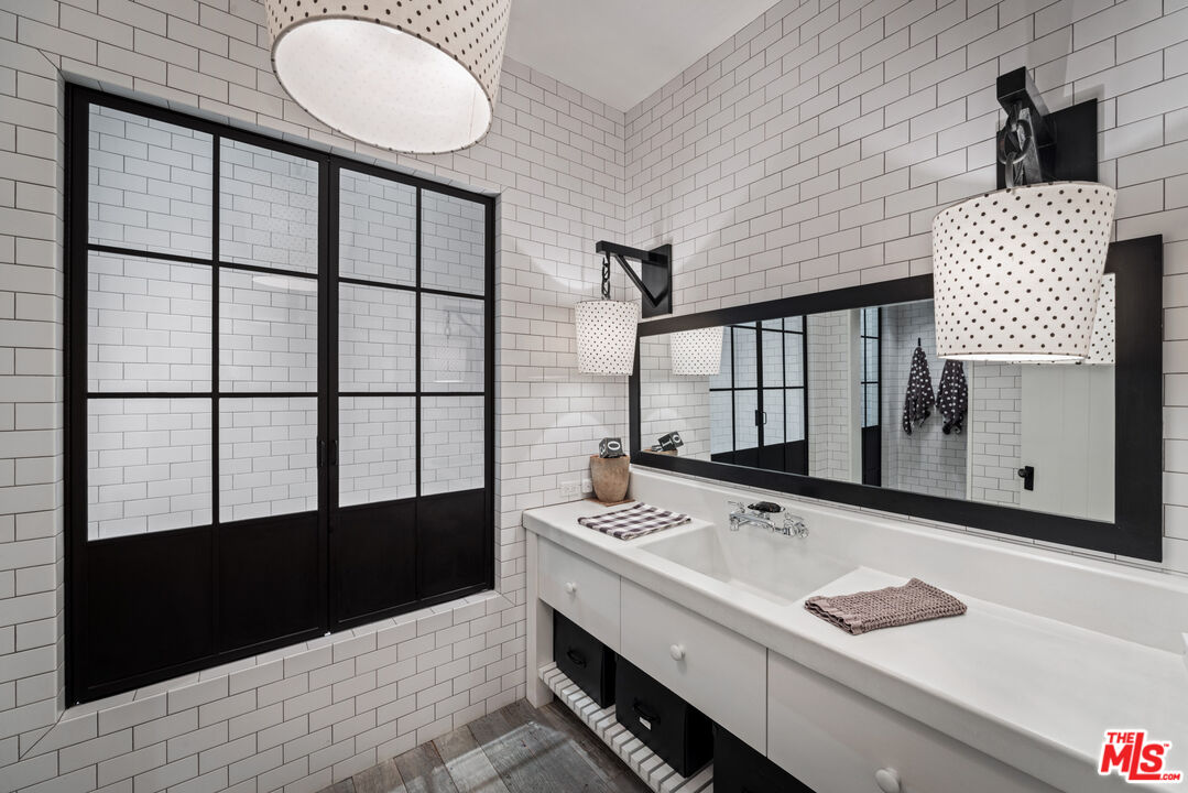 13215 Riviera Ranch Road Los Angeles, CA 90049 - Photo 28 of 37 a bathroom with a sink and a mirror