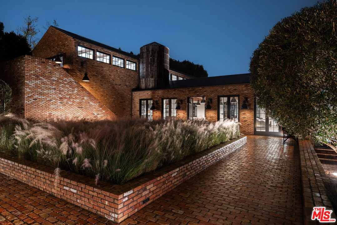 13215 Riviera Ranch Road Los Angeles, CA 90049 - Photo 33 of 37 a view of a house with backyard and sitting area