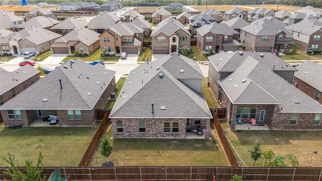 3816 Blacksmith Road Aubrey, TX 76227 - Photo 29 of 30 Rear exterior with a covered patio, brick facade, and fenced yard