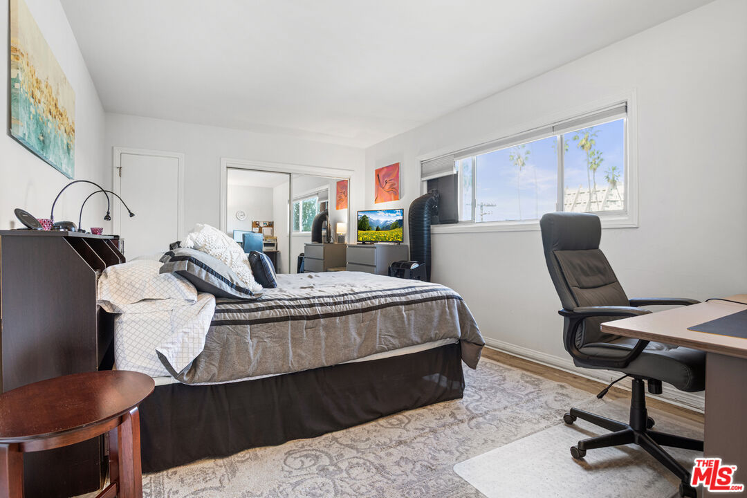2002 4th Street, Unit 312 Santa Monica, CA 90405 - Photo 17 of 22 a bedroom with a bed a desk and chair with it