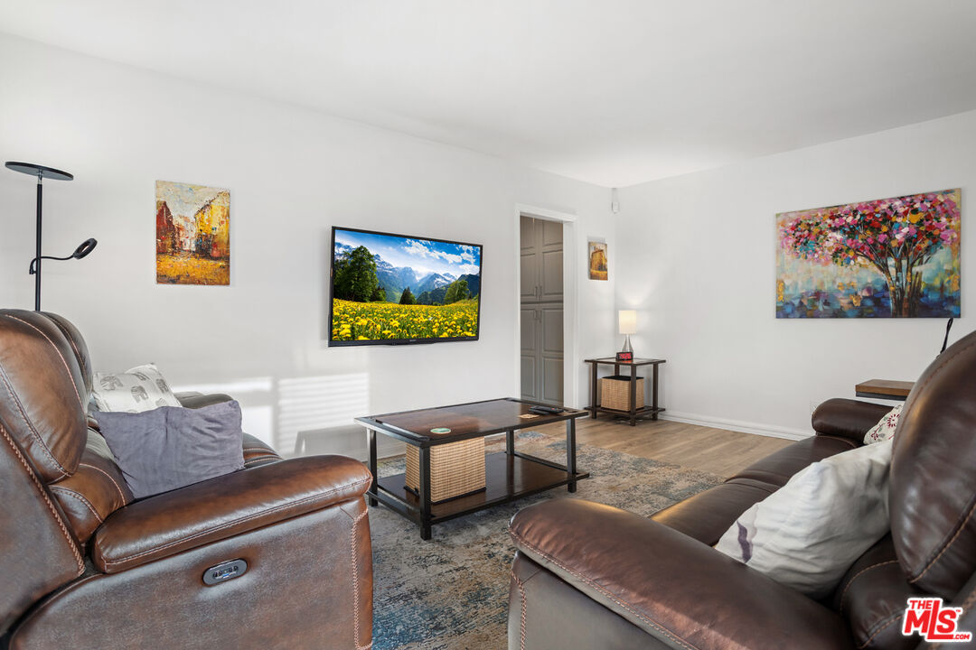 2002 4th Street, Unit 312 Santa Monica, CA 90405 - Photo 4 of 22 a living room with furniture and a flat screen tv