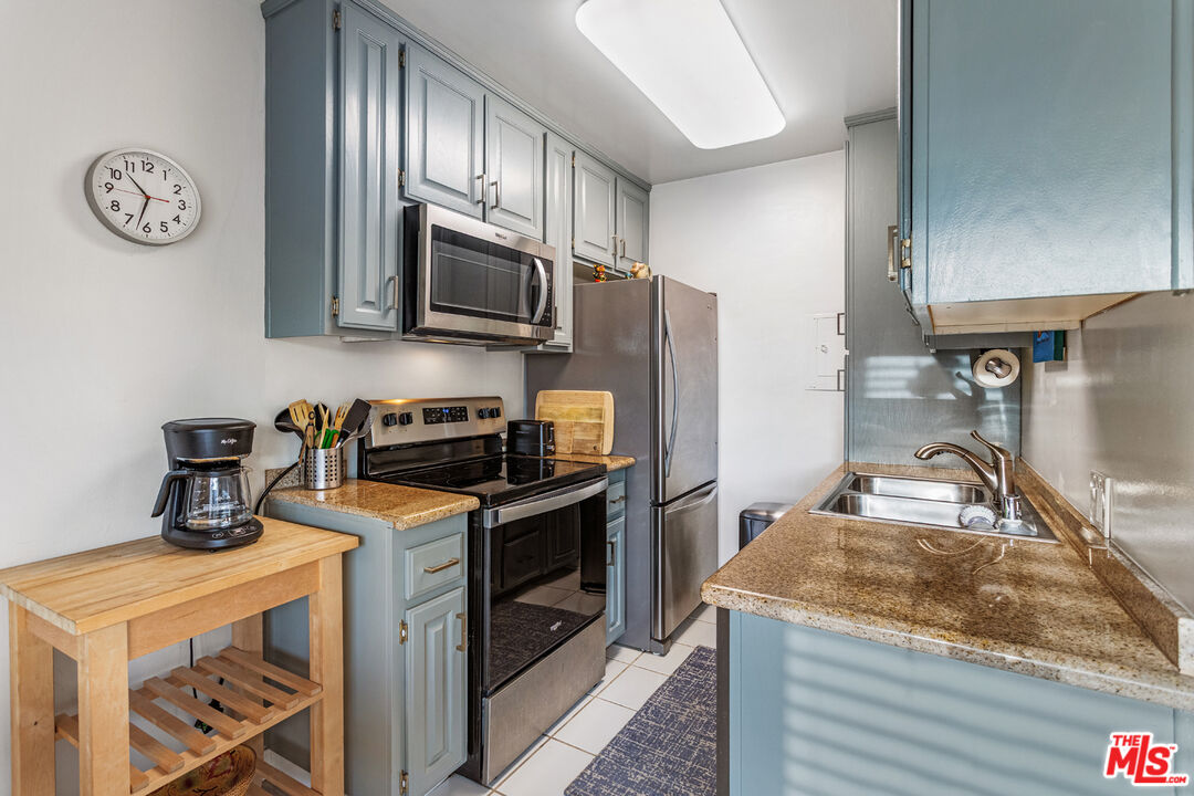 2002 4th Street, Unit 312 Santa Monica, CA 90405 - Photo 8 of 22 a kitchen with stainless steel appliances granite countertop a sink stove and refrigerator