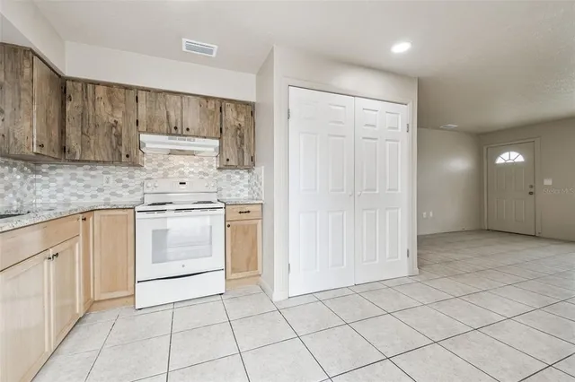 a kitchen with white cabinets a sink and appliances