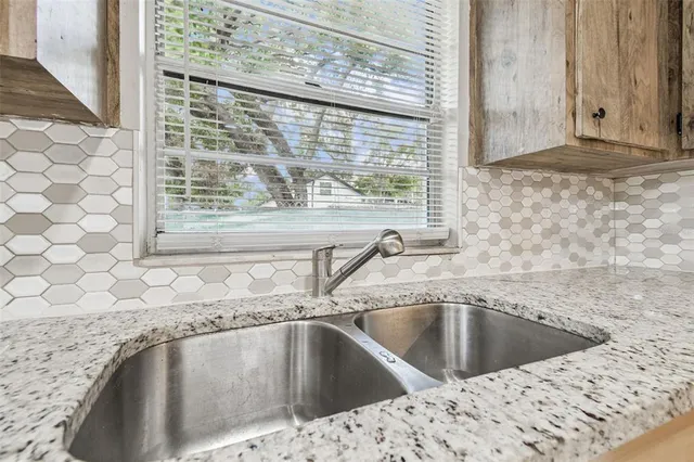a view of a sink and dishwasher with wooden floor