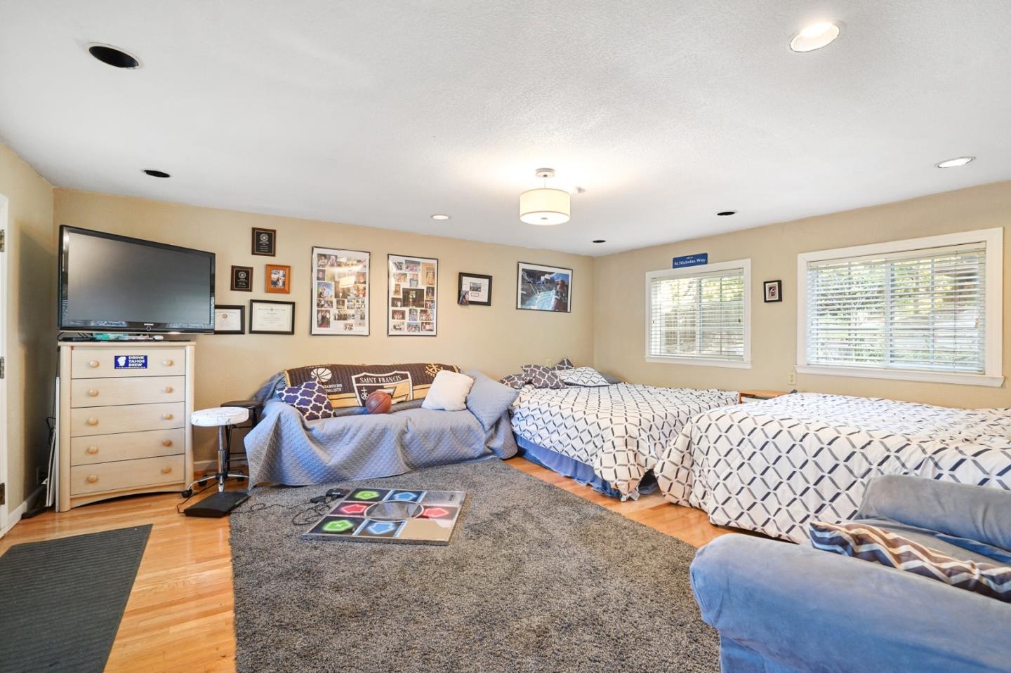 14160 Miranda Road Los Altos Hills, CA 94022 - Photo 15 of 30 a bedroom with furniture and a flat screen tv