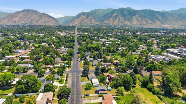 395 North 400 West Logan, UT 84321 - Photo 37 of 48 Expansive residential area featuring a broad boulevard, abundant mature trees, and a distant mountainous backdrop