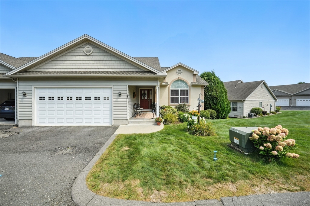 46 Palmer Road, Unit 28 Monson, MA 01057 - Photo 1 of 38 a view of a white house with a big yard and potted plants